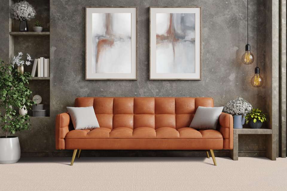 beige patterned carpet in retro style living room with leather couch and grey washed accent wall
